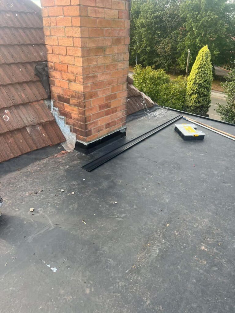 This is a photo of a flat roof which has just been repaired, there is also a chimney stack and some leadwork has also been dressed. Works carried out by LJ Roofing Priory Vale